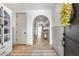 Inviting foyer with tile floors, arched doorways, wainscoting and a decorative rug at 9742 W Los Gatos Dr, Peoria, AZ 85383