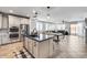 Open-concept kitchen with stainless steel appliances, an island with a sink, and adjacent living space at 9742 W Los Gatos Dr, Peoria, AZ 85383