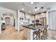 Open kitchen with stainless steel appliances, a kitchen island with seating, and an archway to another room at 9742 W Los Gatos Dr, Peoria, AZ 85383