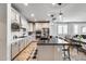 Modern kitchen with stainless steel appliances, island with seating, and open layout into the dining area at 9742 W Los Gatos Dr, Peoria, AZ 85383