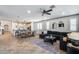 Spacious living room that opens to the kitchen boasts a modern design and comfortable seating at 9742 W Los Gatos Dr, Peoria, AZ 85383