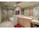 Well-lit bathroom with a walk-in shower, vanity, and bathtub at 9904 E Lookout Mountain Dr, Scottsdale, AZ 85262