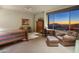 Cozy bedroom with desk, seating area, and window overlooking mountain views at 9904 E Lookout Mountain Dr, Scottsdale, AZ 85262