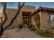 Inviting front entrance with stone accents, mature landscaping and a walkway to the front door at 9904 E Lookout Mountain Dr, Scottsdale, AZ 85262