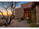 Charming front entrance with mature trees, stone accents and landscaped front yard at 9904 E Lookout Mountain Dr, Scottsdale, AZ 85262