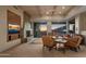 Cozy living room with a stone fireplace, built-in shelving and a large sliding glass doors at 9904 E Lookout Mountain Dr, Scottsdale, AZ 85262