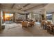 Spacious living room with wood-beamed ceilings, fireplace, and sliding glass doors to the patio at 9904 E Lookout Mountain Dr, Scottsdale, AZ 85262