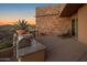 Stone patio with built-in grill and desert landscape overlooking mountain views at 9904 E Lookout Mountain Dr, Scottsdale, AZ 85262