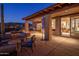 Covered patio featuring an outdoor dining area, built-in grill, and fire pit at 9904 E Lookout Mountain Dr, Scottsdale, AZ 85262