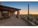 Enjoy the views from this covered patio featuring a built-in grill and desert landscaping at 9904 E Lookout Mountain Dr, Scottsdale, AZ 85262