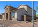 Exterior view of the home featuring stone accents and brown shutters at 10110 W El Cortez Pl, Peoria, AZ 85383