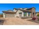 Property featuring a three-car garage with brick paved driveway and stone accents at 10110 W El Cortez Pl, Peoria, AZ 85383