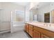 Bright bathroom featuring double sinks, glass block window, and separate tub and shower at 10588 E Tierra Buena Ln, Scottsdale, AZ 85255