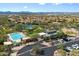 Aerial view of community pool, tennis courts and recreation center with plentiful parking and desert landscaping at 10588 E Tierra Buena Ln, Scottsdale, AZ 85255