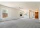 Bright living room with a ceiling fan and natural light coming in through the large windows at 10588 E Tierra Buena Ln, Scottsdale, AZ 85255