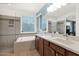 Bathroom features double sinks with marble counters, tile flooring, a soaking tub, and glass shower at 11305 W Monte Vista Rd, Avondale, AZ 85392