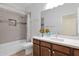 Well-lit bathroom featuring a shower-over-tub and a decorative backsplash over a modern vanity at 11305 W Monte Vista Rd, Avondale, AZ 85392