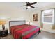 Bedroom features tile floors, ceiling fan and decorative bedspread at 11305 W Monte Vista Rd, Avondale, AZ 85392