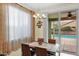 Inviting dining area featuring stylish lighting, a table with seating for four, and a sliding glass door to the patio at 11305 W Monte Vista Rd, Avondale, AZ 85392