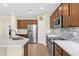 The kitchen features stainless steel appliances, ample countertop space, and modern lighting at 11305 W Monte Vista Rd, Avondale, AZ 85392