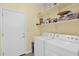 Laundry room with washer, dryer and open shelving at 11305 W Monte Vista Rd, Avondale, AZ 85392