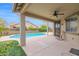 Outdoor patio with ceiling fan overlooking the pool and backyard at 11305 W Monte Vista Rd, Avondale, AZ 85392