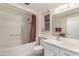 Bright bathroom featuring a shower-tub combo, and a white vanity with countertop space at 12535 W Brandywine Dr, Sun City West, AZ 85375