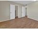 Bedroom featuring wood floors and access to walk-in closets and additional rooms at 13808 N Silverbell Dr, Sun City, AZ 85351