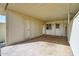 View of the covered carport featuring a concrete floor, two entry doors and a window to the home at 13808 N Silverbell Dr, Sun City, AZ 85351