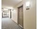 Well-lit condo hallway with carpet, neutral walls, decorative trim, and a unit door at 14000 N 94Th St # 3190, Scottsdale, AZ 85260