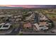 Tranquil community aerial view showcasing homes with terracotta roofs, lush green spaces, and a serene neighborhood at 15145 W Catalina Dr, Goodyear, AZ 85395