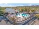 Stunning clubhouse view showing a spacious pool, lounge chairs, umbrellas, and lush landscape, perfect for leisure at 15145 W Catalina Dr, Goodyear, AZ 85395