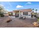 Spacious backyard with a covered patio, barbecue, and dining area at 15145 W Catalina Dr, Goodyear, AZ 85395