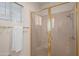 Bathroom with glass shower enclosure, linen closet, and ample lighting at 15145 W Catalina Dr, Goodyear, AZ 85395