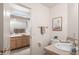 Bathroom featuring a toilet, sink, and vanity with neutral colored tile at 15145 W Catalina Dr, Goodyear, AZ 85395