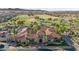 Aerial view of a clubhouse featuring a terracotta tile roof and lush landscaping at 15145 W Catalina Dr, Goodyear, AZ 85395