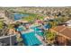 Aerial view of multiple community pools with palm trees and shaded areas, perfect for relaxation at 15145 W Catalina Dr, Goodyear, AZ 85395