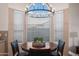 Charming dining area with a round wood table and decorative chandelier at 15145 W Catalina Dr, Goodyear, AZ 85395