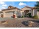 Home exterior featuring desert landscaping, a two car garage, and an inviting entrance at 15145 W Catalina Dr, Goodyear, AZ 85395