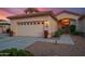 Charming single-story home featuring a well-manicured yard, neutral stucco, a tile roof, and an attached two-car garage at 15145 W Catalina Dr, Goodyear, AZ 85395