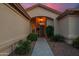 Beautifully landscaped front entrance with an arched porch, walkway lighting, and meticulously maintained greenery, inviting you inside at 15145 W Catalina Dr, Goodyear, AZ 85395