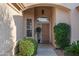 Charming front entrance with an arched window, mature landscaping, and covered entry at 15145 W Catalina Dr, Goodyear, AZ 85395