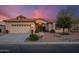 Charming single-story home featuring a tile roof, desert landscaping, and a two-car garage at 15145 W Catalina Dr, Goodyear, AZ 85395