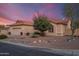 Charming single-story home featuring a tile roof, desert landscaping, and a two-car garage at 15145 W Catalina Dr, Goodyear, AZ 85395