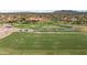 Aerial view of a manicured golf course, showcasing lush greenery and golf carts at 15145 W Catalina Dr, Goodyear, AZ 85395