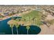 Aerial view of a golf course pond surrounded by palm trees and residential homes at 15145 W Catalina Dr, Goodyear, AZ 85395