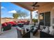 Expansive patio with upscale outdoor seating under a covered area with ceiling fan at 15145 W Catalina Dr, Goodyear, AZ 85395