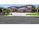 Exterior of desert home featuring multiple garages, well-manicured lawns, and desert landscaping at 15240 N Clubgate Dr # 162, Scottsdale, AZ 85254