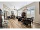 Inviting living room featuring wood floors, plantation shutters, and a charming chandelier above the dining table at 15240 N Clubgate Dr # 162, Scottsdale, AZ 85254