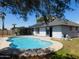 Backyard with pool, fence, solar panels on roof, patio area, and lush greenery at 1531 W Naranja Ave, Mesa, AZ 85202